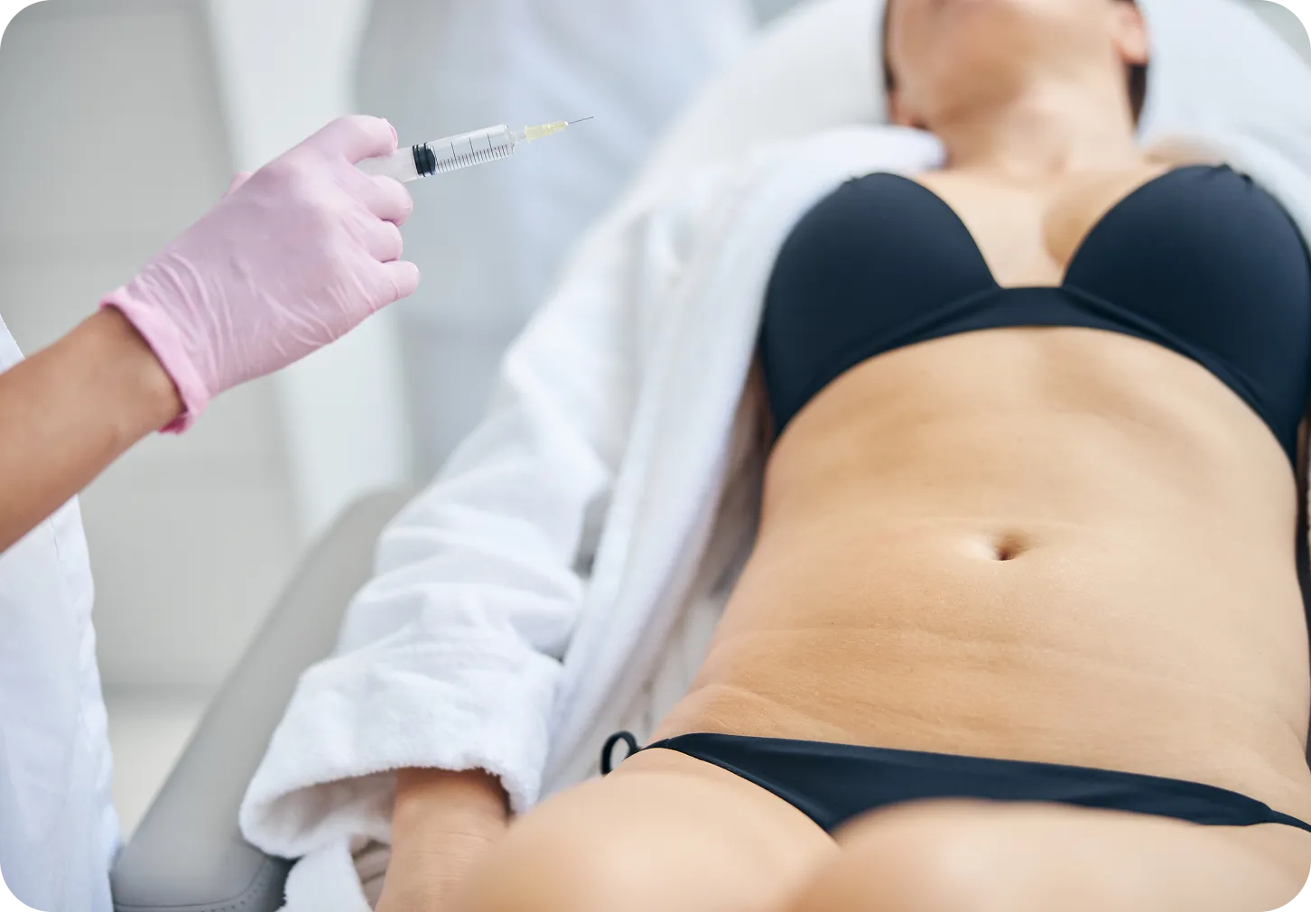 Provider giving a LipoDissolve injection to the abdomen